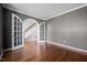 Office with gray walls, hardwood floors, and arched French doors leading to a staircase and other rooms at 125 Kelekent Ln, Cary, NC 27518