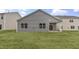 Spacious backyard featuring a covered patio and ample green space for outdoor activities at 128 Pisgah St, Sanford, NC 27330
