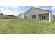 The backyard features newly laid sod, a gray fence, and a covered patio at 128 Pisgah St, Sanford, NC 27330