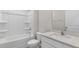 Pristine white bathroom featuring a shower-tub combo and a modern vanity with a solid surface at 128 Pisgah St, Sanford, NC 27330