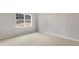 Cozy bedroom with plush carpet, a large window, and neutral wall colors at 128 Pisgah St, Sanford, NC 27330