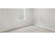 Serene bedroom featuring neutral walls, plush carpeting, and ample natural light from the window at 128 Pisgah St, Sanford, NC 27330