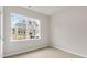 Bright bedroom featuring a large window offering an outside neighborhood view at 128 Pisgah St, Sanford, NC 27330