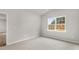 Bright bedroom featuring neutral carpet, gray walls, and a large window with natural light at 128 Pisgah St, Sanford, NC 27330