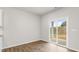 Well-lit dinette area with sleek wood floors leading to outdoor space at 128 Pisgah St, Sanford, NC 27330