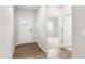 Inviting foyer with wood-look flooring and natural light streaming in from the front door at 128 Pisgah St, Sanford, NC 27330