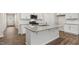 Modern kitchen with a large island, granite countertops, stainless steel appliances, and ample cabinet space at 128 Pisgah St, Sanford, NC 27330