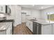 Well-lit kitchen featuring stainless steel appliances, granite countertops, and white cabinets at 128 Pisgah St, Sanford, NC 27330