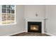 Comfortable living room features a fireplace, a large window and ample lighting at 128 Pisgah St, Sanford, NC 27330