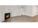 Open living room showcases a cozy fireplace, and sleek flooring at 128 Pisgah St, Sanford, NC 27330