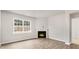Bright living room showcases a cozy fireplace, large window and sleek flooring at 128 Pisgah St, Sanford, NC 27330