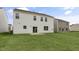 A home's backyard featuring a lawn, patio and ample space between neighboring homes at 129 Pisgah St, Sanford, NC 27330