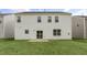A home's backyard with a patio, lawn, and sliding glass door at 129 Pisgah St, Sanford, NC 27330