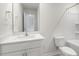 Bright bathroom with a white vanity, mirror, and a shower and tub combination at 129 Pisgah St, Sanford, NC 27330