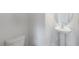 Bathroom featuring a pedestal sink, modern toilet and crisp white paint at 129 Pisgah St, Sanford, NC 27330