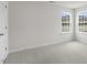 Bedroom with neutral carpeting, white walls, and windows that fill the room with natural light at 129 Pisgah St, Sanford, NC 27330