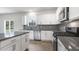 Modern kitchen with stainless steel appliances, a gray backsplash and granite countertop island at 129 Pisgah St, Sanford, NC 27330