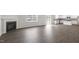 Open-concept living space with a fireplace, modern floors, and a view of the kitchen at 129 Pisgah St, Sanford, NC 27330