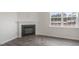 Living room with a modern fireplace, window, and beautiful wood-look flooring at 129 Pisgah St, Sanford, NC 27330
