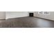 Living room featuring modern wood-look floors, a fireplace, and a large window at 129 Pisgah St, Sanford, NC 27330