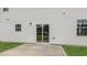 Concrete patio in the backyard with sliding glass doors and vinyl siding at 129 Pisgah St, Sanford, NC 27330