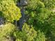An aerial view of a home nestled among lush, mature trees, offering a private and serene setting at 1304 Deboy St, Raleigh, NC 27606