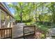 Wooden deck with railings overlooking the lush yard with mature trees at 1304 Deboy St, Raleigh, NC 27606