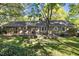 Expansive backyard featuring a wooden deck, mature trees, and plenty of space for outdoor activities at 1304 Deboy St, Raleigh, NC 27606