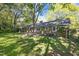 The backyard has a wooden deck and mature trees at 1304 Deboy St, Raleigh, NC 27606