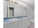 Bathroom featuring dual sinks, blue tiled countertops, and ample vanity storage at 1304 Deboy St, Raleigh, NC 27606