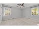Bedroom with two windows allowing natural light, ceiling fan and neutral carpeting at 1304 Deboy St, Raleigh, NC 27606