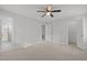 Spacious bedroom with carpet flooring, ceiling fan, and ensuite bathroom with a glass shower door at 1304 Deboy St, Raleigh, NC 27606