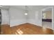 Dining room featuring wood floors, wainscoting, and transitional light fixture at 1304 Deboy St, Raleigh, NC 27606