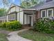 Charming home entrance with a covered porch, lush greenery, and well-defined street address at 1304 Deboy St, Raleigh, NC 27606