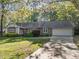 Lovely ranch-style home with an attached garage, manicured lawn, and beautiful landscaping at 1304 Deboy St, Raleigh, NC 27606