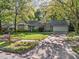 Attractive home with a well-kept lawn, mature trees, and a convenient two-car garage at 1304 Deboy St, Raleigh, NC 27606