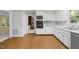 White kitchen featuring hard wood floors and stainless-steel appliances at 1304 Deboy St, Raleigh, NC 27606