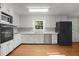 White kitchen with stainless-steel appliances and hard wood floors at 1304 Deboy St, Raleigh, NC 27606