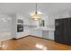 White kitchen with stainless-steel appliances and hardwood floors and breakfast nook at 1304 Deboy St, Raleigh, NC 27606