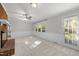 Bright living room with fireplace, large windows and natural light and a door leading to the backyard at 1304 Deboy St, Raleigh, NC 27606