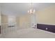 Bright living room featuring carpet, natural light, stairs, and view to the home's entrance at 1304 Deboy St, Raleigh, NC 27606