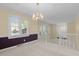 Bright living room featuring carpet, natural light, and stairs to a lower level at 1304 Deboy St, Raleigh, NC 27606