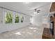Bright living room featuring large windows, a ceiling fan, and neutral decor at 1304 Deboy St, Raleigh, NC 27606