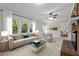 Living room featuring a sofa, armchair, and large windows offering natural light at 1304 Deboy St, Raleigh, NC 27606