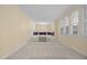 Spacious living area with large windows, bright lighting, and carpeted flooring at 1304 Deboy St, Raleigh, NC 27606