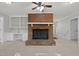 Cozy living room with a brick fireplace, ceiling fan, and custom built-ins at 1304 Deboy St, Raleigh, NC 27606