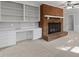 Living room featuring a brick fireplace, built-in shelving, and a neutral color scheme at 1304 Deboy St, Raleigh, NC 27606