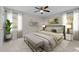 Bedroom featuring a stylish design with a ceiling fan and bedside lighting, large window, and decor at 1304 Deboy St, Raleigh, NC 27606