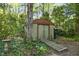 Storage shed surrounded by lush foliage, providing practical outdoor storage at 1304 Deboy St, Raleigh, NC 27606