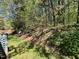 Lush greenery in the backyard, with a gentle slope down to the yard, offering a serene and private outdoor space at 1308 Oakridge Ave # 3, Henderson, NC 27536